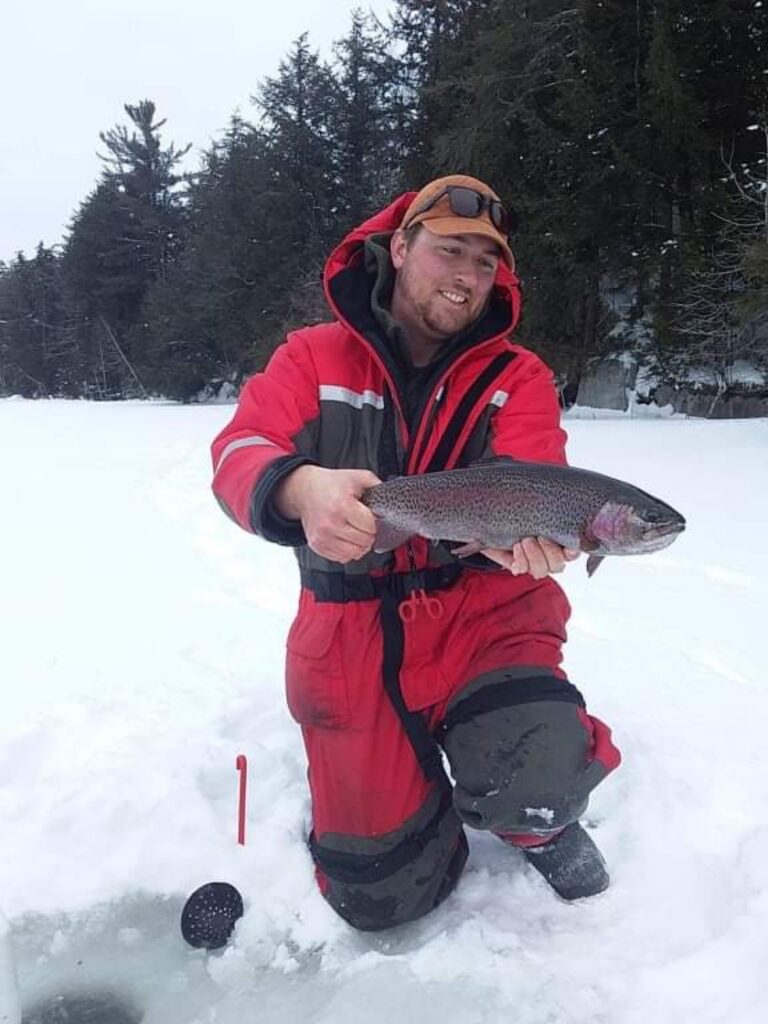 Chris Saunders holding a tip-up caught Rainbow Trout